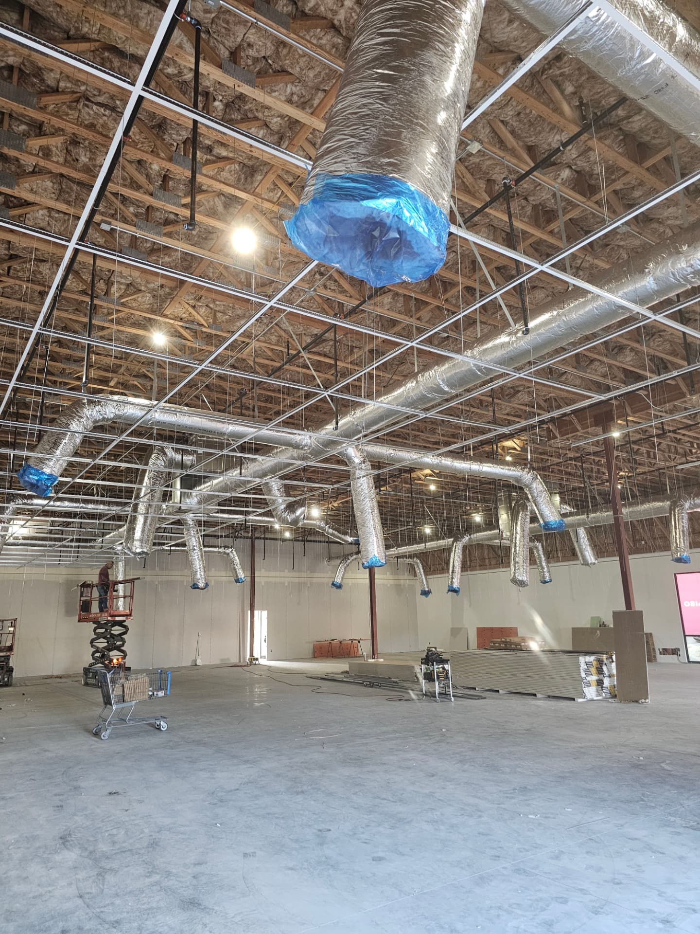 Large commercial interior build-out with overhead systems